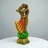 Handcrafted clay statue of a couple in a loving embrace, standing on a decorative base with green and gold accents.