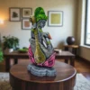 Handcrafted clay Saraswati idol with veena and swan, placed on a lotus pedestal, displayed in a modern living room setting.