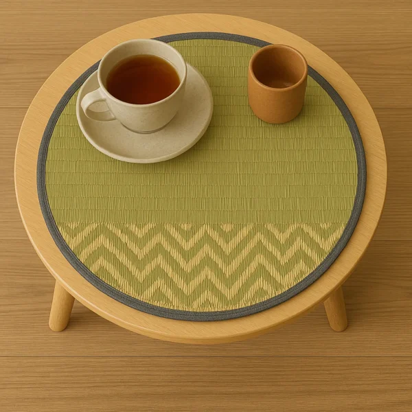 Round river grass mat used as a tea table mat with ceramic cup and terracotta tumbler on light wooden table