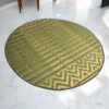3ft round handmade river grass rug with chevron pattern on white marble flooring in a modern living space