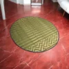 3ft round handmade river grass carpet with chevron pattern on a white marble floor in a modern home