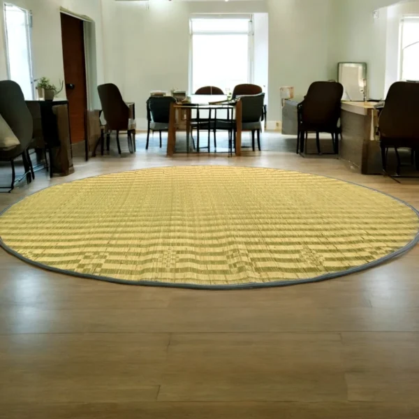 4ft round river grass (Madurkathi) rug placed in a spacious living room with wooden flooring and natural lighting