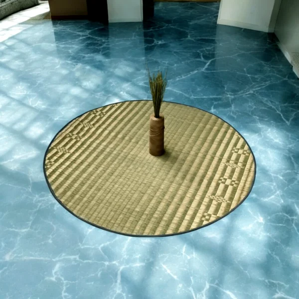 4ft round Madurkathi river grass mat placed on a blue marble floor with a decorative vase centerpiece in natural light