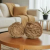 Two large balls of thick 5mm natural jute twine placed on a round wooden table in a cozy living room setting.