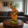 Handcrafted Baul Man Clay Statue with Ektara placed on a wooden table in a modern living room setting
