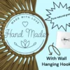 Close-up of handmade natural grass wall décor with a "Hand Made" label, a wall hanging hook, and a “Pure natural grass” badge on a light blue background.