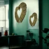 Two heart-shaped natural grass wall hangings displayed on a green accent wall in a cozy indoor space.