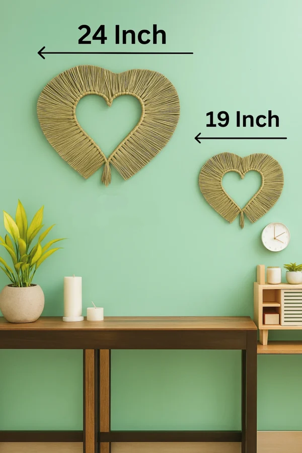 Two circular handmade wall hangings made from natural grass, sized 24 inches and 16 inches, mounted on a neutral beige wall above a wooden table with plants.