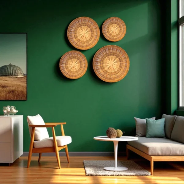 Four handwoven bamboo wall baskets arranged on a dark green wall in a modern living room with wooden furniture and sunlight