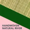 Close-up view of handwoven river grass mat with detailed green fabric border showcasing natural texture and weaving pattern.