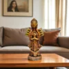 Handmade burnt clay Maa Durga terracotta idol placed on a wooden table in a modern living room setting.