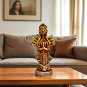 Handmade burnt clay Maa Durga terracotta idol placed on a wooden table in a modern living room setting.