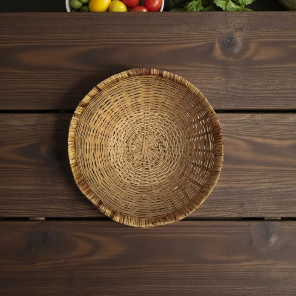 Top view of a handmade bamboo basket on a wooden table – natural round storage basket