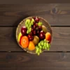 Handwoven bamboo basket filled with fresh fruits like apples, oranges, grapes, and kiwi on a wooden table.