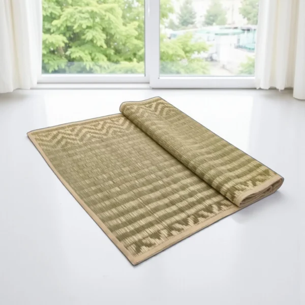 Natural green handwoven Madurkathi mat half rolled near window – eco-friendly sleeping and yoga mat by Bhumikart