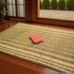 Handwoven Korai Grass Mat placed on wooden floor near window with a folded cloth on top