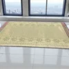 Extra large handwoven Madurkathi korai grass floor mat with traditional border placed in a modern indoor space with city view windows
