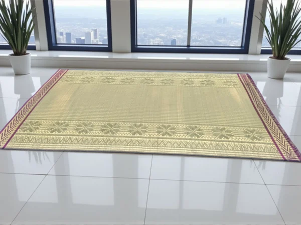 Extra large handwoven Madurkathi korai grass floor mat with traditional border placed in a modern indoor space with city view windows