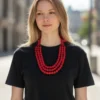 Woman wearing handmade red fabric bead multi-layer necklace with black t-shirt and casual outfit
