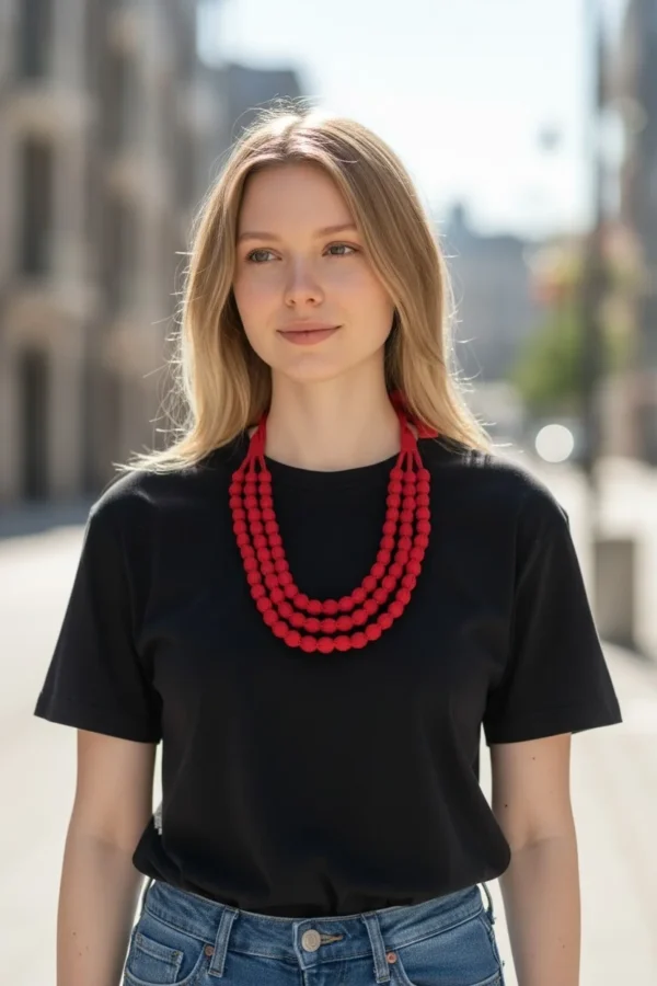 Woman wearing handmade red fabric bead multi-layer necklace with black t-shirt and casual outfit
