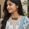 indian woman wearing handmade blue floral terracotta necklace and earrings set with traditional kurta close up